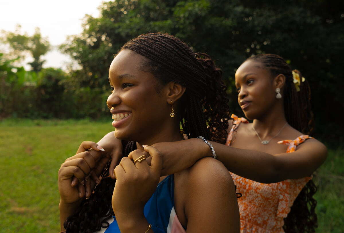 A heartfelt moment between two young African women outdoors